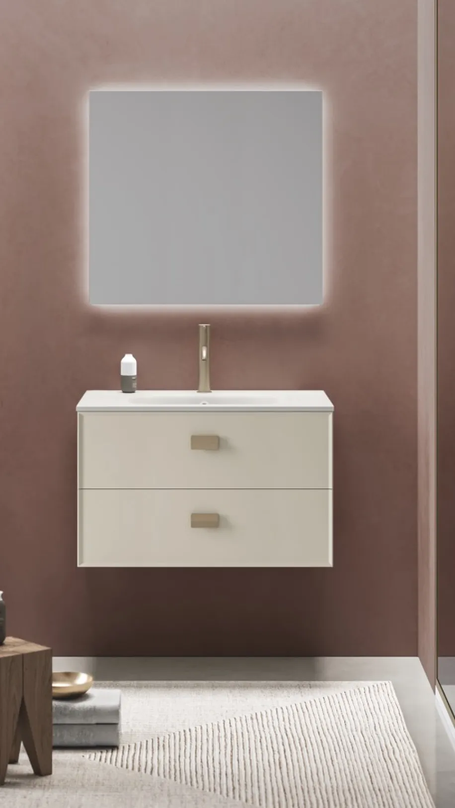 Badmöbel-Set in zartem beige mit goldenen Details, beleuchtetem Spiegel und Dusche in warmem Farbkonzept.